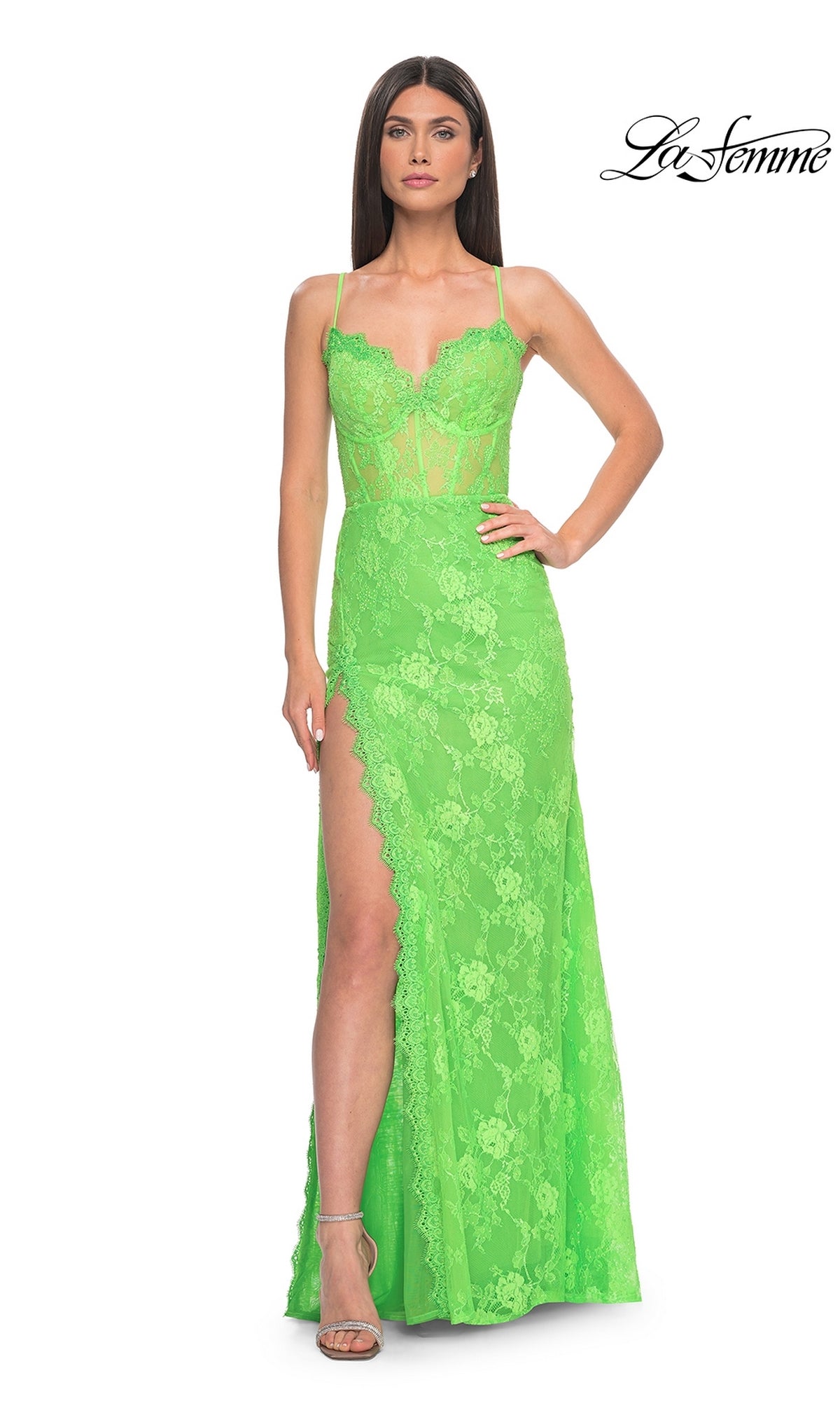 A woman in heels wears the La Femme Bright Long Lace Prom Dress 32441, featuring neon lace, spaghetti straps, a sheer corset bodice, and a high slit. She stands against a white background with the La Femme logo in the corner.